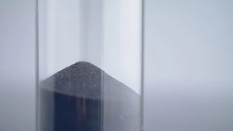 Close up macro shot of sand clock / hourglass sand pouring in slow motion. Stock Footage 273114154