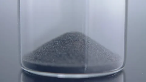 Close up macro shot of sand clock / hourglass sand pouring in slow motion. Stock Footage 273114296