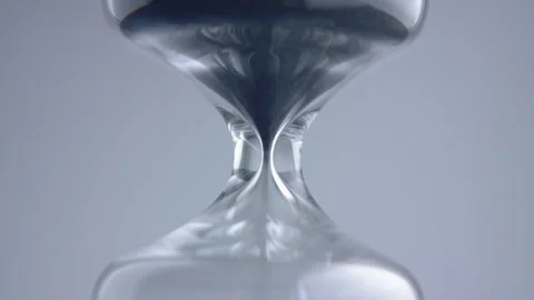 Close up macro shot of sand clock / hourglass sand pouring in slow motion. Stock Footage 273114357