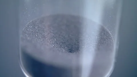 Close up macro shot of sand clock / hourglass sand pouring in slow motion. Stock Footage 273114677