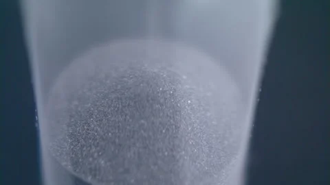 Close up macro shot of sand clock / hourglass sand pouring in slow motion. Stock Footage 273114711