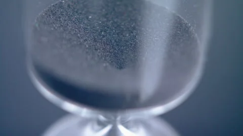 Close up macro shot of sand clock / hourglass sand pouring in slow motion. Stock Footage 273114923