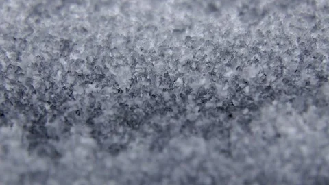 Close-up macro shot of textured snow crystals glistening under bright light.. Stock Footage 343532362