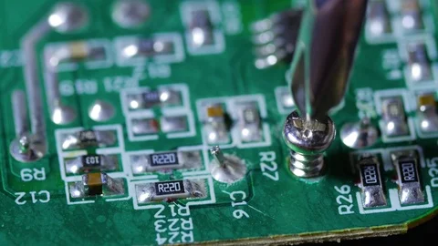Close up macro shot twisting in screw on an electronic chip circuit board Video stock 70239782