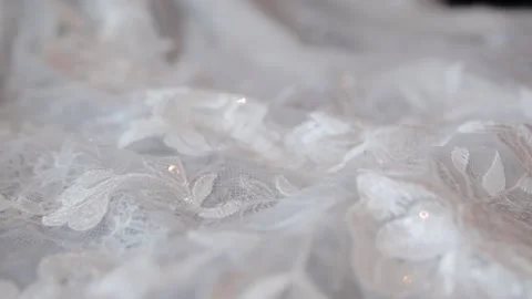 Close up macro shot view of wedding dress laces. Slow reverse movement with the Stock Footage 234754427