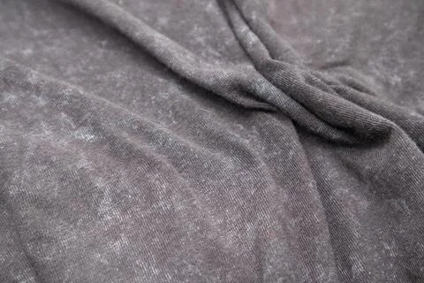 Close-up macro shot of washed grey fabric texture with soft folds and acid-.. Stock Photos
