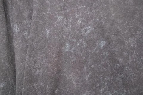 Close-up macro shot of washed grey fabric texture with soft folds and acid-.. Stock Photos
