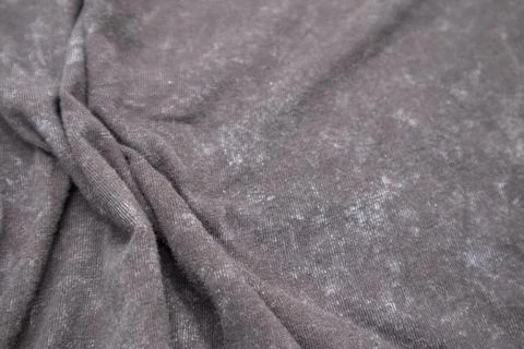 Close-up macro shot of washed grey fabric texture with soft folds and acid-.. Stock Photos