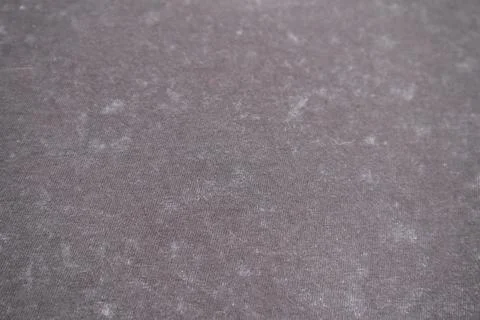 Close-up macro shot of washed grey fabric texture with soft folds and acid-.. Stock Photos