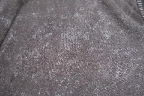 Close-up macro shot of washed grey fabric texture with soft folds and acid-.. Stock Photos