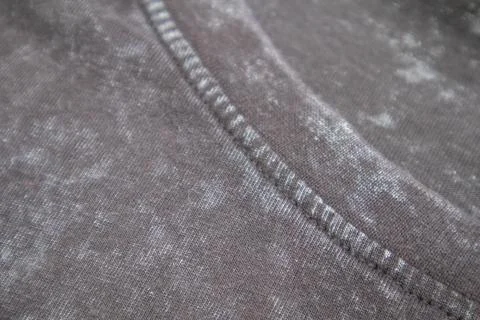 Close-up macro shot of washed grey fabric texture with soft folds and acid-.. Stock Photos