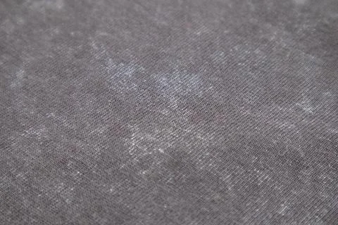 Close-up macro shot of washed grey fabric texture with soft folds and acid-.. Stock Photos