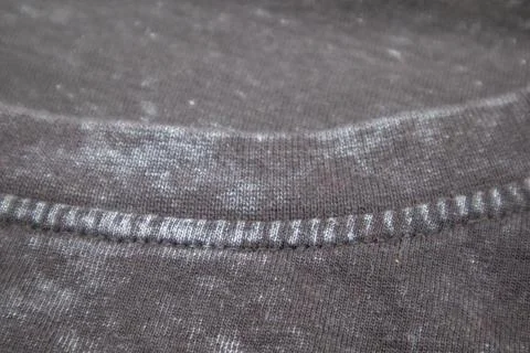 Close-up macro shot of washed grey fabric texture with soft folds and acid-.. Stock Photos