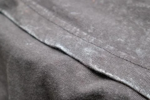 Close-up macro shot of washed grey fabric texture with soft folds and acid-.. Stock Photos