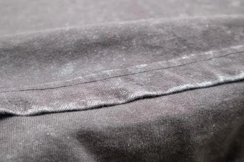 Close-up macro shot of washed grey fabric texture with soft folds and acid-.. 库存照片