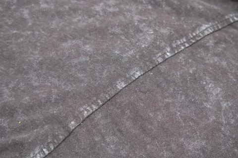 Close-up macro shot of washed grey fabric texture with soft folds and acid-.. Stock Photos