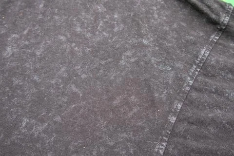 Close-up macro shot of washed grey fabric texture with soft folds and acid-.. Stock Photos