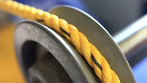 Close up macro shot of Yellow Rope Winding on an Industrial Pulley in factory. Video stock 318512524