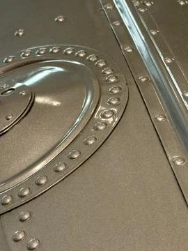 Close-up macro of silver colored metal machine with many rivets Stock Photos