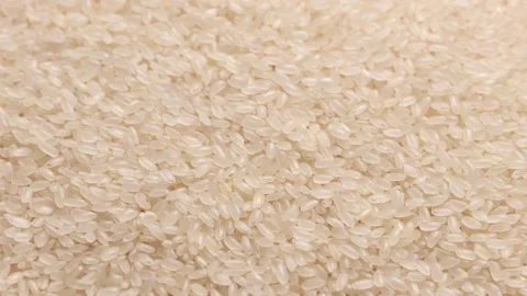 Close up macro texture of uncooked white rice grains filling the frame as food Stock-Footage 347459287