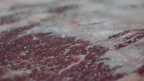 Close-up, macro tracking shot over raw, fresh, marbled Angus beef steak with coa Stock Footage 332811659