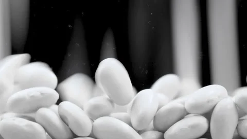 Close-up macro video of dried uncooked white bean seeds fall down Stock Footage 285902931