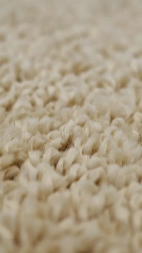 Close up macro video revealing the soft, fluffy texture of a wooly beige fleece Stock Footage 342942604