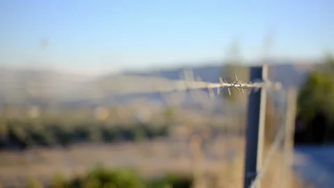 Close up macro view of barbed wire made of metal. Rack focus on knots of barbed Stock Footage 165474782