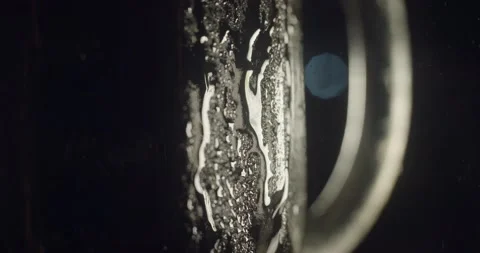 Close up macro view of dark beer in glass with condensate drops flowing down Stock Footage 142735286
