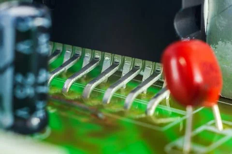 Close-up macro view of electronic components on a green circuit board with .. Stock Photos