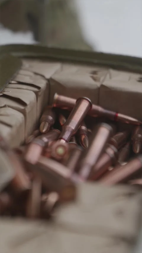 Close-up macro view of soldier hands selecting ammunition bullets on snowy .. Stock Footage 333612691