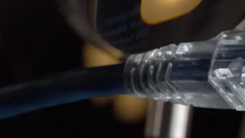 Close up macro view of transparent Ethernet cable connector with plug and Stock Footage 343711538