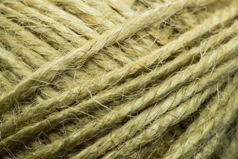 Close-up macro view of twine or string from natural fabric wrapped in a ball. 스톡 사진