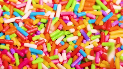 Close Up Macro View of Vibrant Rainbow Sugar Sprinkles Falling Stock Footage 325689719