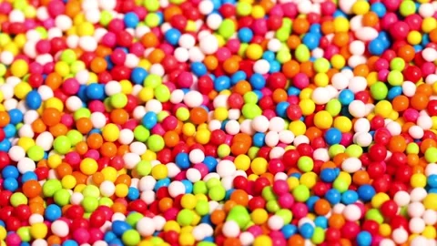 Close Up Macro View of Vibrant Rainbow Sprinkles Falling and Settling Stock Footage 326093963