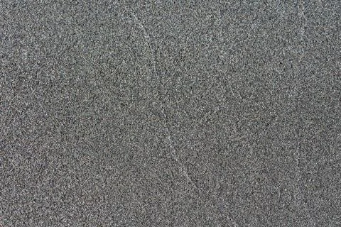 Close-up macro view volcanic sand black color. Detailed nature pattern texture Stock Photos