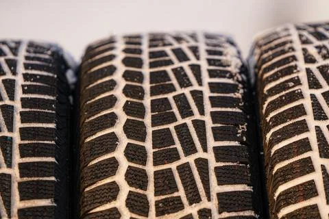 Close macro view winter new tires covered by snow.. Stock Photos