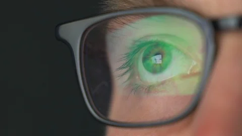 Close up macro view of young man in glasses eye moving fast staring at Stock Footage 122089189