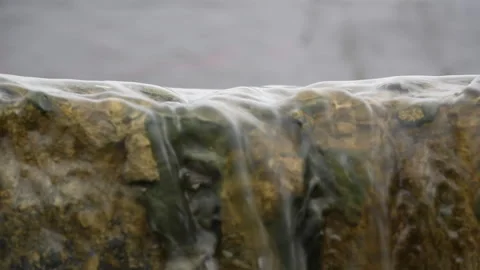 Close-Up Macro of Water Flowing Over Stone Stock Footage 310024792