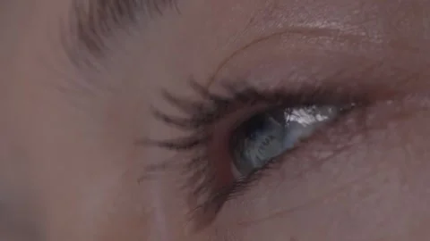 Close-up macro of a woman's eye reflecting New Year's fireworks celebrating the Stock Footage 259169851