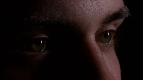 Close up macro of young man eyes looking and searching in the dark Stock Footage 75640654