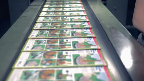 Close up of magazines moving along the conveyor belt, getting collected and put Stock Footage 87252938