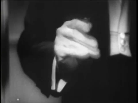 Close-up of magician's hand as he's doing a coin trick, 1930s Stock Footage 64629986