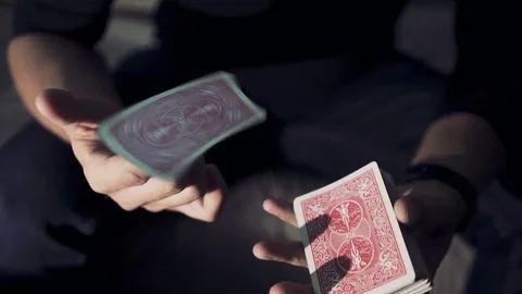 Close-up of a Magician's Hands Performing Card Trick. Card spinning on my finger Stock Footage 85397928