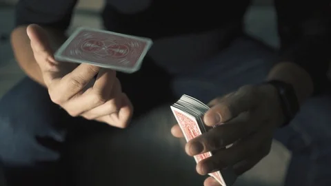 Close-up of a Magician's Hands Performing Card Trick. Card spinning on my finger Stock Footage 89446229