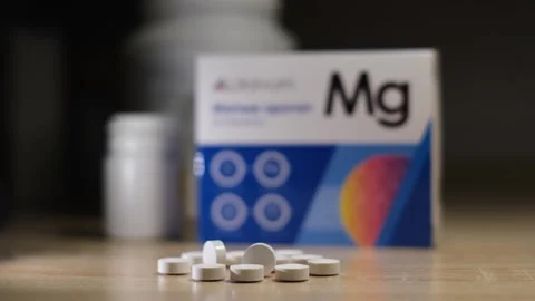 Close-up of magnesium supplement tablets on a table Stock-Footage 334241349