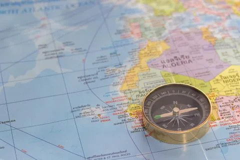 Close up magnetic compass on a world map conceptual of global travel Stock Photos