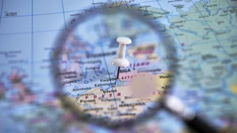 Close up of a magnifying glass over a map highlighting Klaipeda Fotos Stock