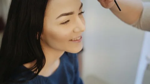Close-up of a make-up artist applying make-up to the eyelash Stock Footage 73646265