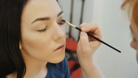 Close-up of a make-up artist applying make-up to the eyelash Stock-Footage 73848905
